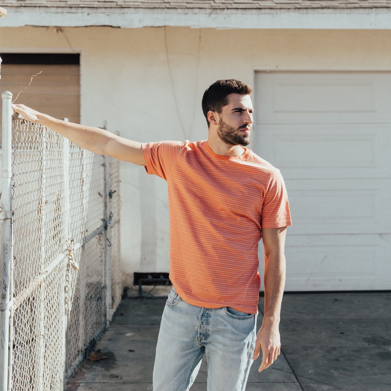 Nixon Striped Tee featuring thin stripes, short sleeves, and a crew neck design, made from eco-friendly materials.