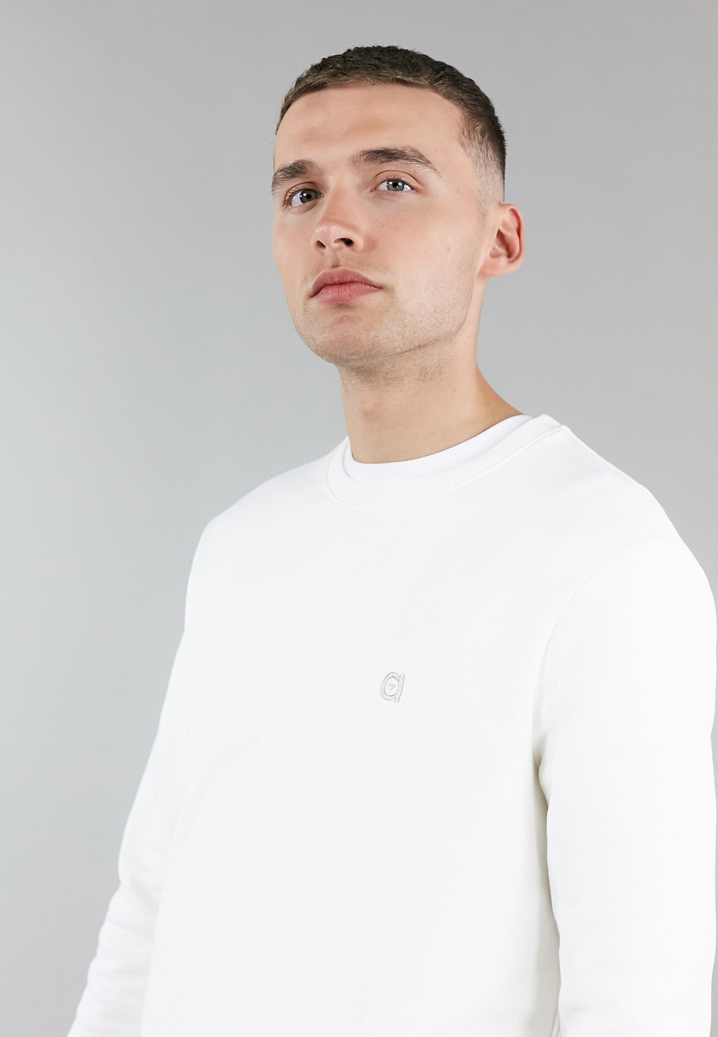 Off white crew neck sweatshirt made from 100% organic cotton, featuring an embroidered logo and a regular fit.