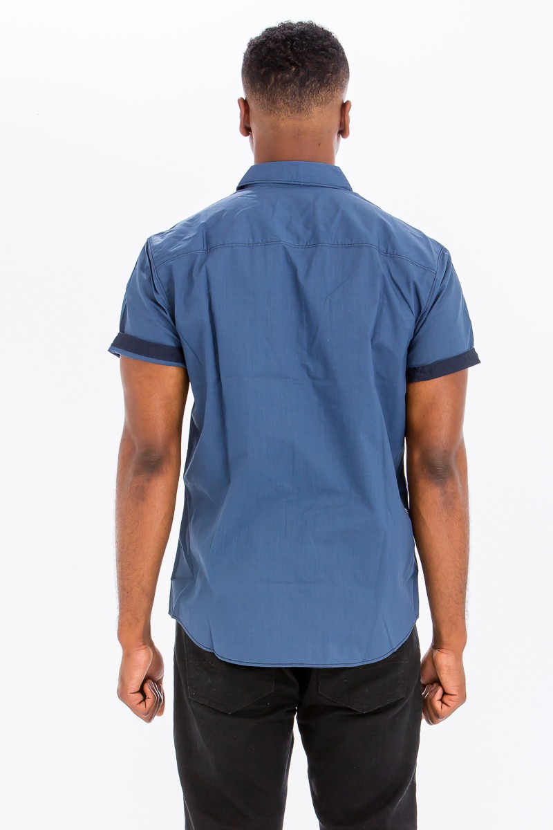 Outline Stitch Two Pocket Shirt in solid color with short sleeves and two buttoned chest pockets, designed for casual wear.