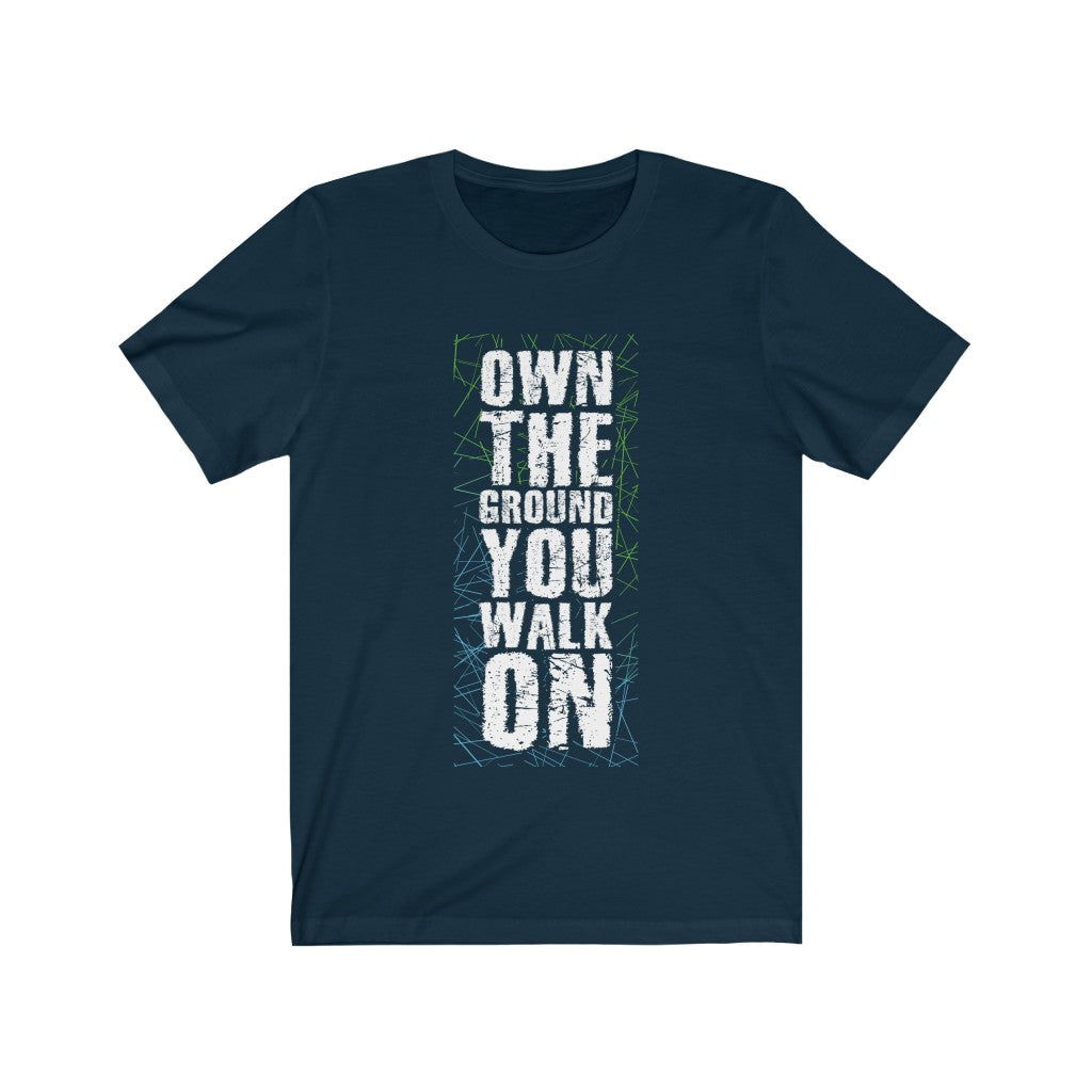 A soft cotton t-shirt with the phrase 'Own the Ground You Walk On' printed on it, showcasing its lightweight and comfortable design.