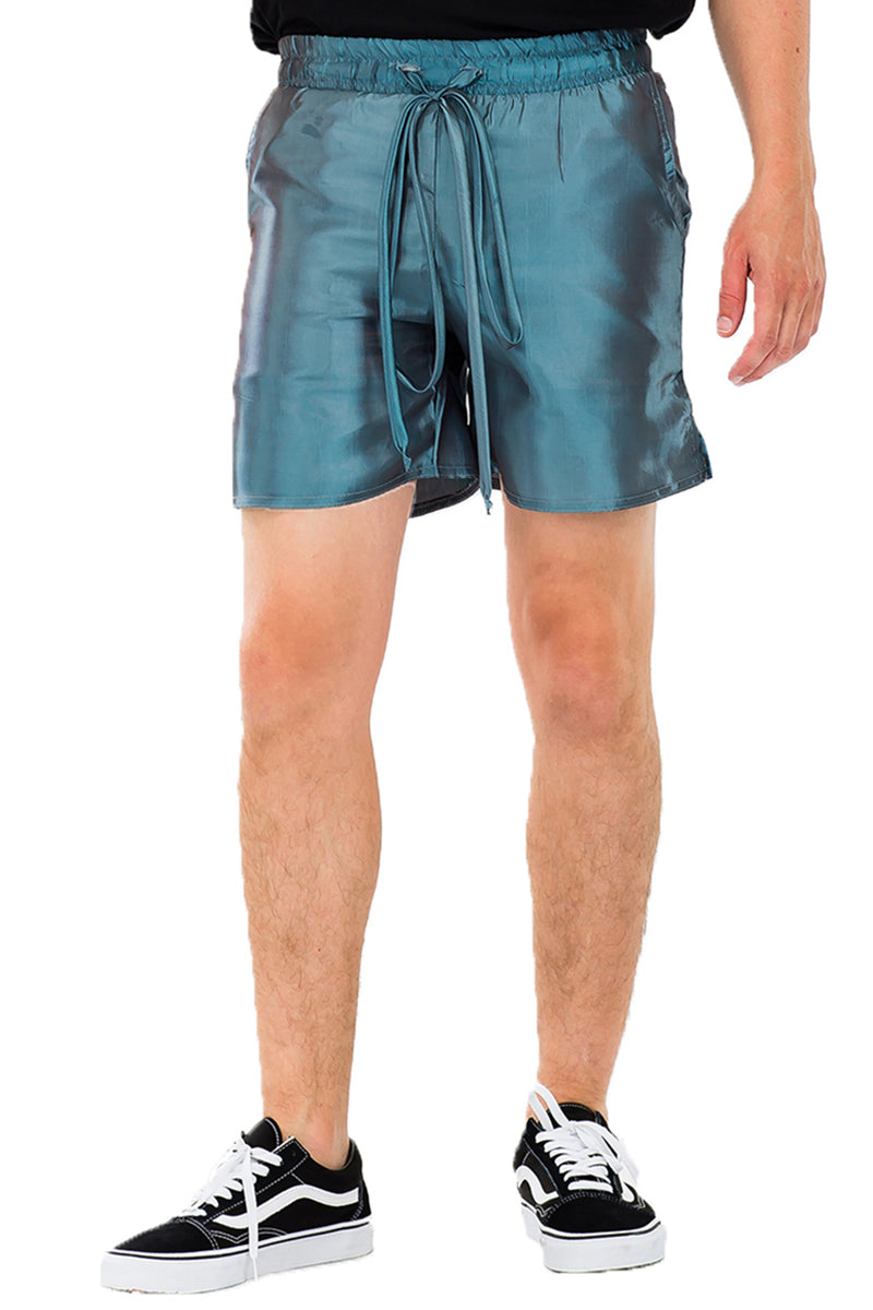 A pair of iridescent polyester peacock sheen shorts featuring an elastic waist with drawstring and two standard pockets, displayed on a neutral background.