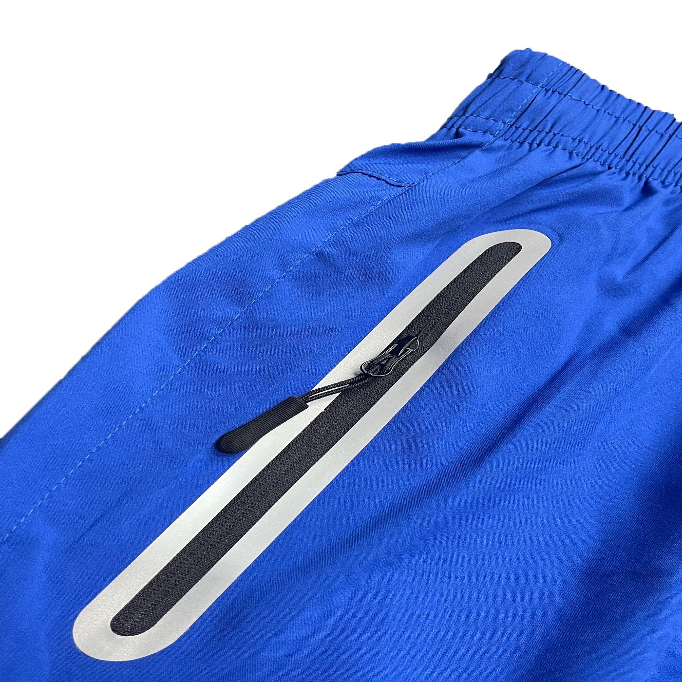 A pair of lightweight PERFORMANCE RUNNING SHORTS featuring zippered pockets and a reflective zipper, made from 100% polyester.