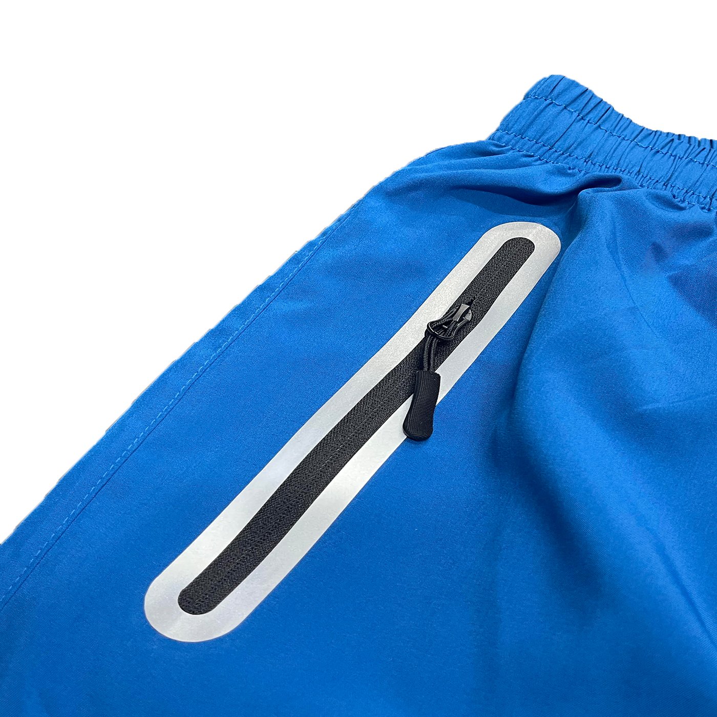 Lightweight PERFORMANCE RUNNING SHORTS featuring zippered pockets and reflective zipper for enhanced safety.