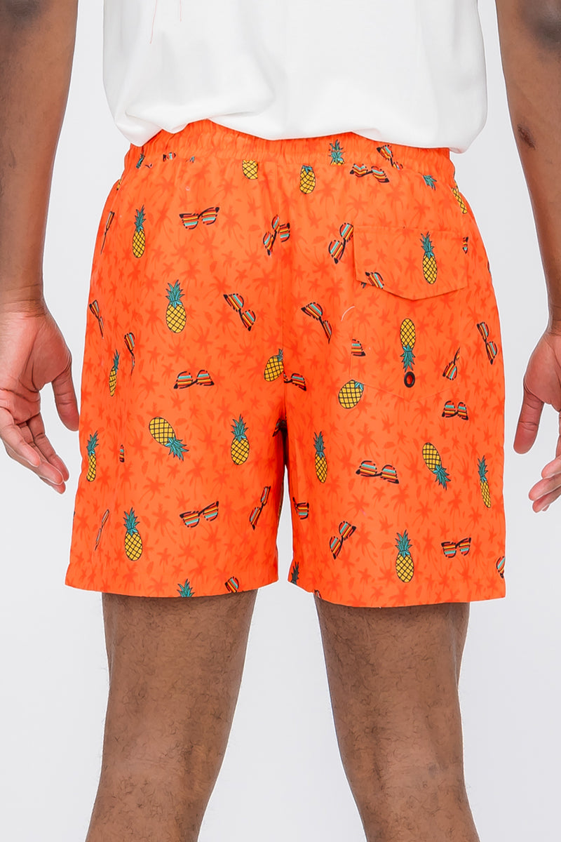 Pineapple Shade Print Swim Shorts featuring a vibrant tropical design, made from 100% polyester with mesh lining and pockets.