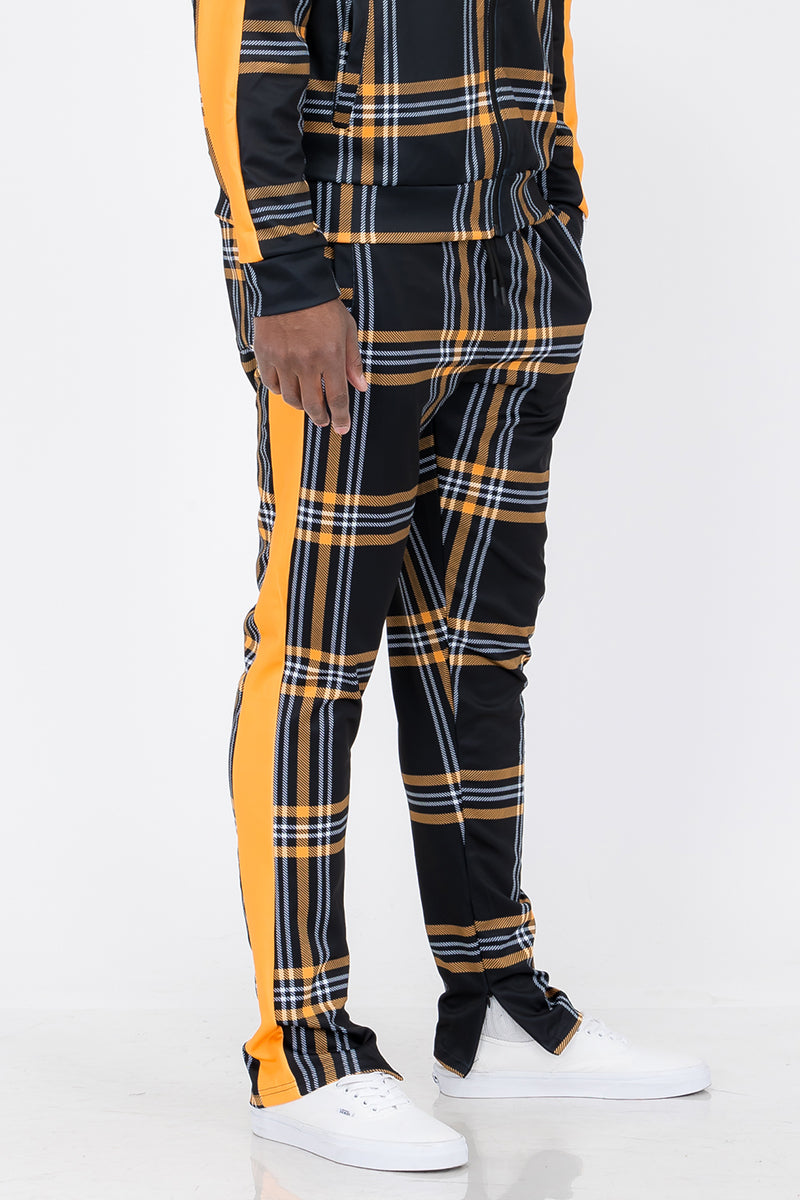 Plaid Out Track Pants featuring an elastic waist, drawstring, and ankle zippers, displayed on a model standing at 5'11 wearing a Large.