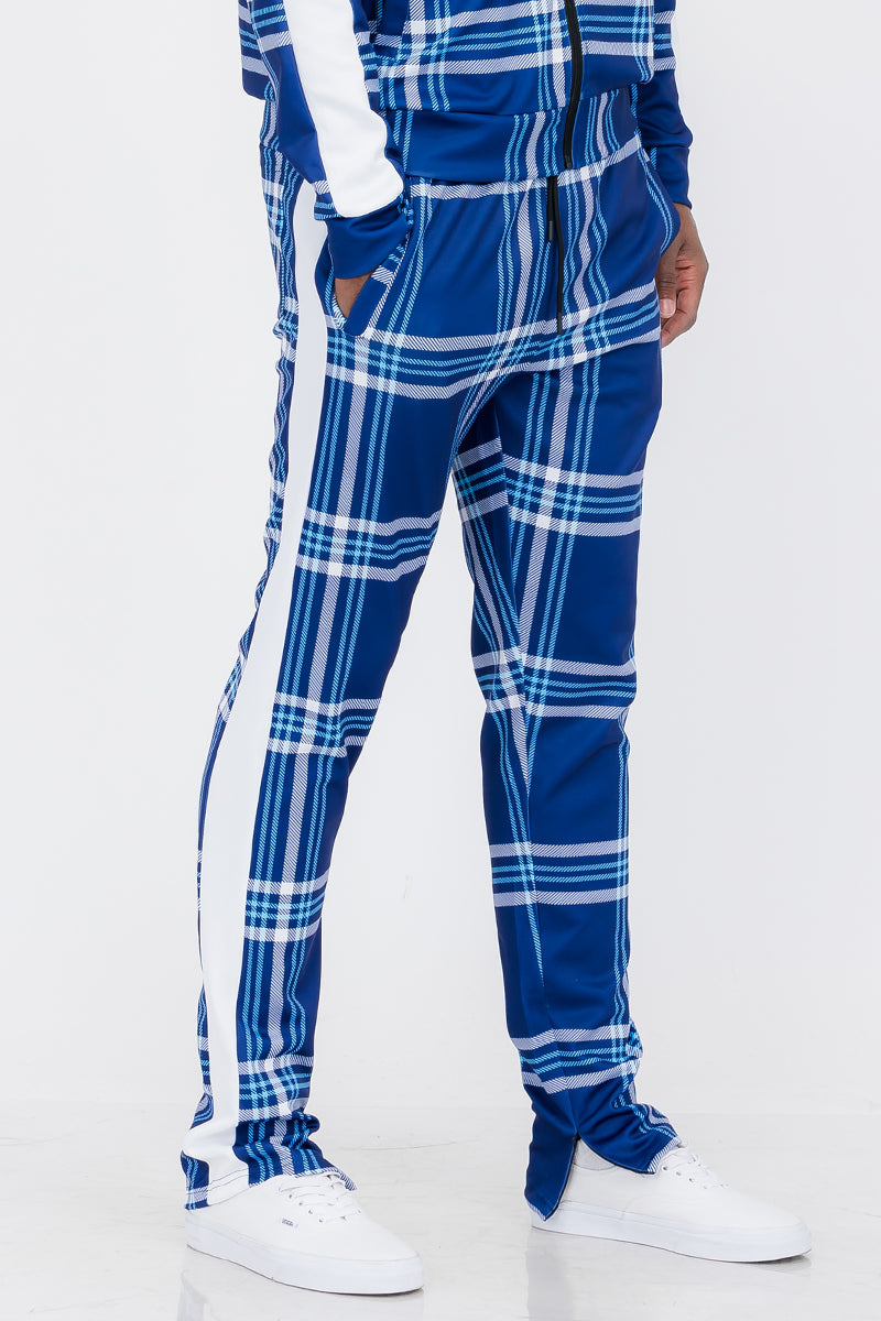 Plaid Out Track Pants featuring an elastic waist, drawstring, and ankle zippers, displayed on a model standing at 5'11 wearing a Large.