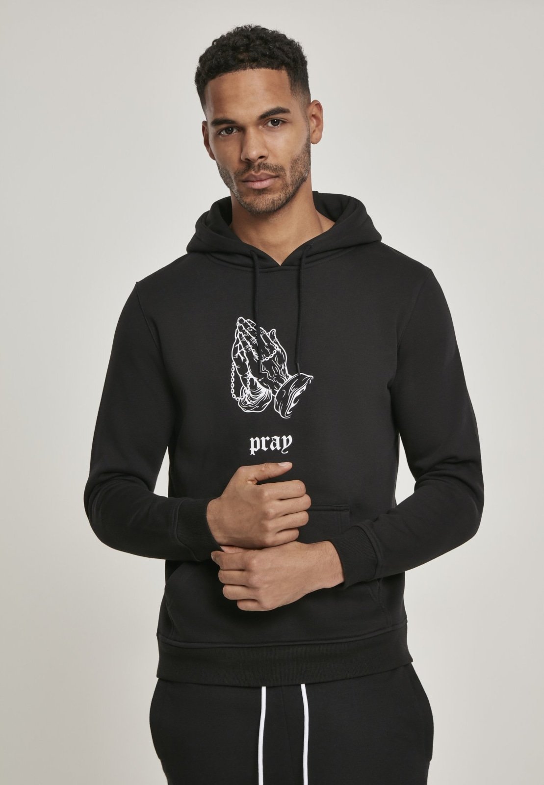 Pray 2 Hoodie featuring a black and white print of folded hands inspired by Albrecht Dürer, with the word 'pray' underneath.