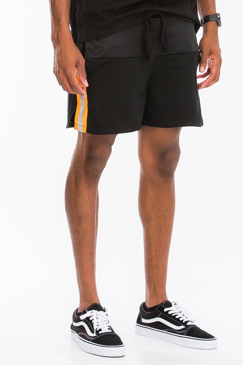 A pair of stylish Quarter Mesh Shorts featuring half mesh and half cotton design, elastic waist with drawstring, and reflective tape along the sides.