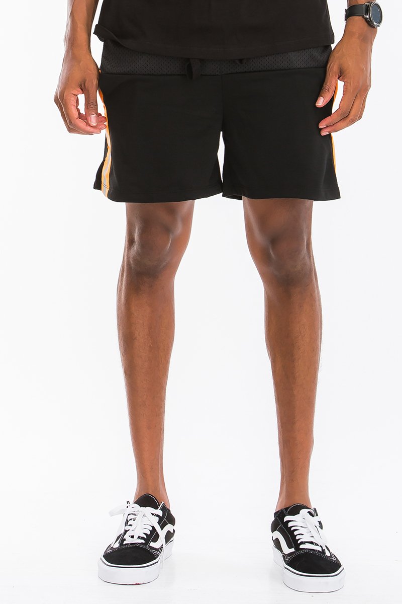 A pair of stylish Quarter Mesh Shorts featuring half mesh and half cotton design, elastic waist with drawstring, and reflective tape along the sides.