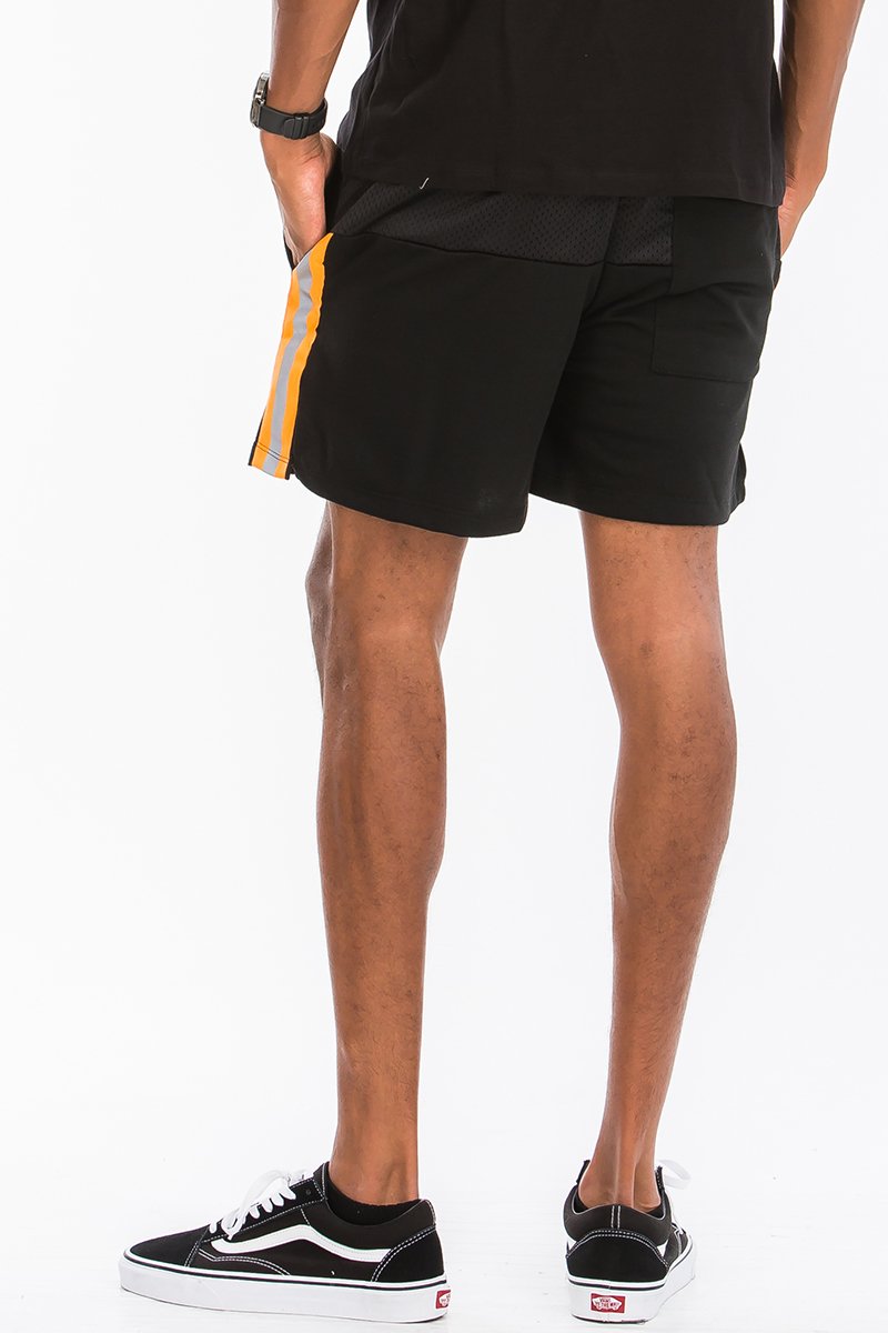 A pair of stylish Quarter Mesh Shorts featuring half mesh and half cotton design, elastic waist with drawstring, and reflective tape along the sides.