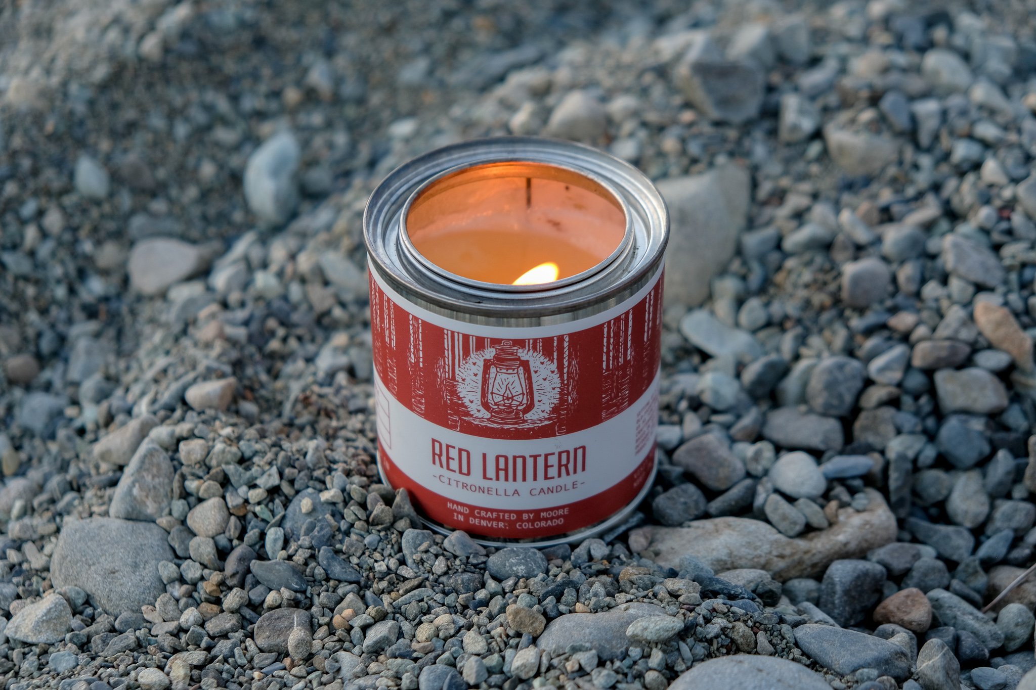 A beautifully crafted Red Lantern Citronella Candle in a vibrant red container, designed to repel insects while providing a warm glow.