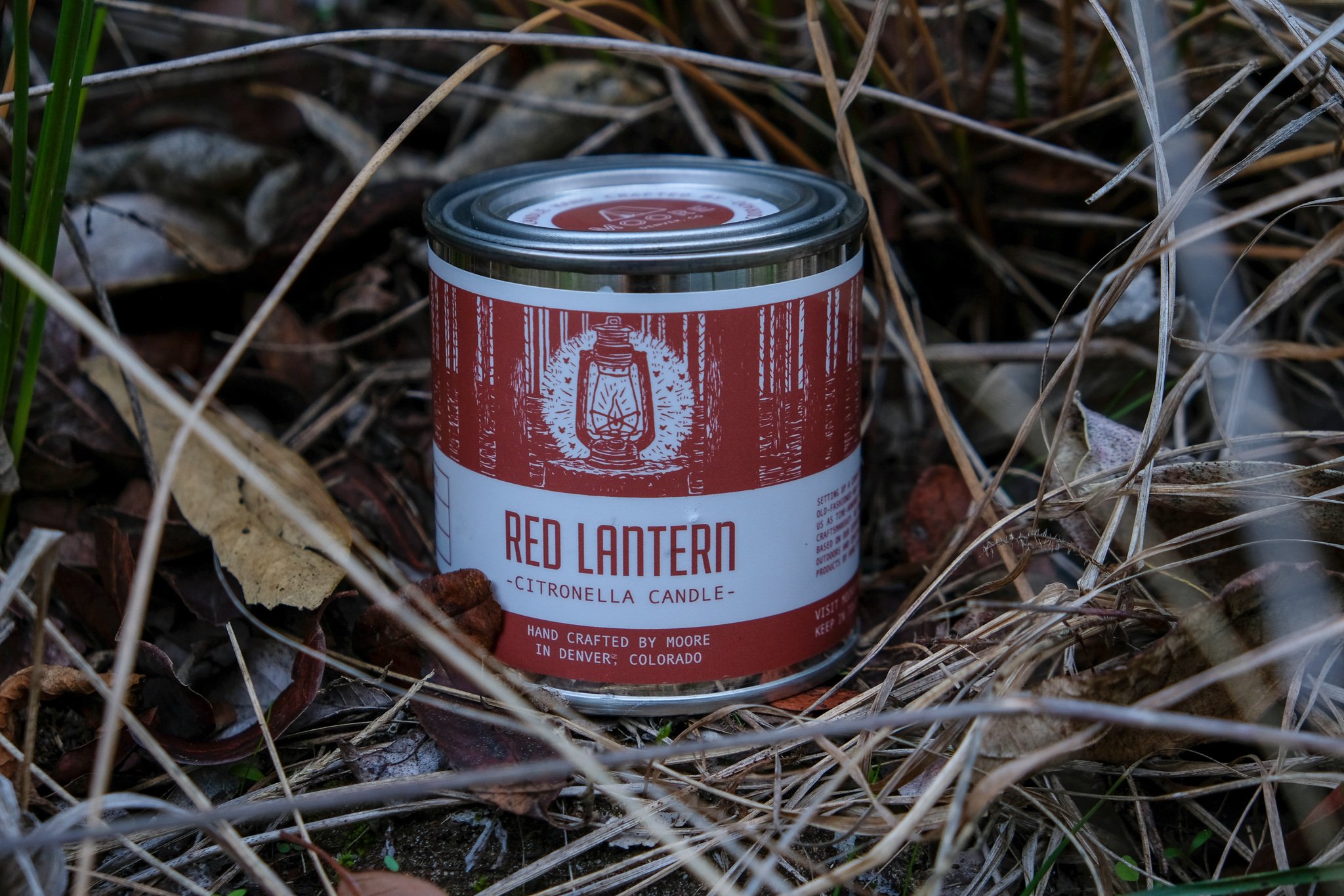 A beautifully crafted Red Lantern Citronella Candle in a vibrant red container, designed to repel insects while providing a warm glow.