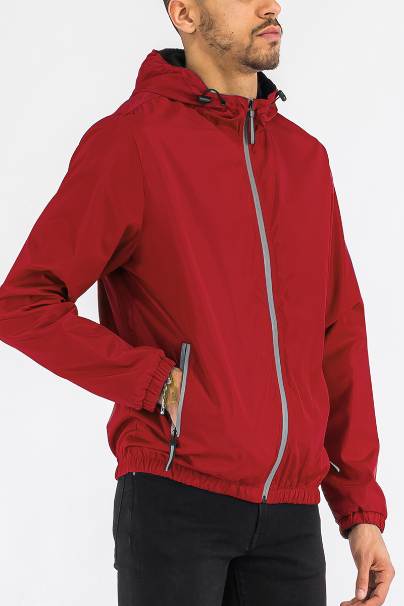 A stylish reflective zip windbreaker jacket in a vibrant color, featuring a full zip closure and hood, ideal for outdoor activities.