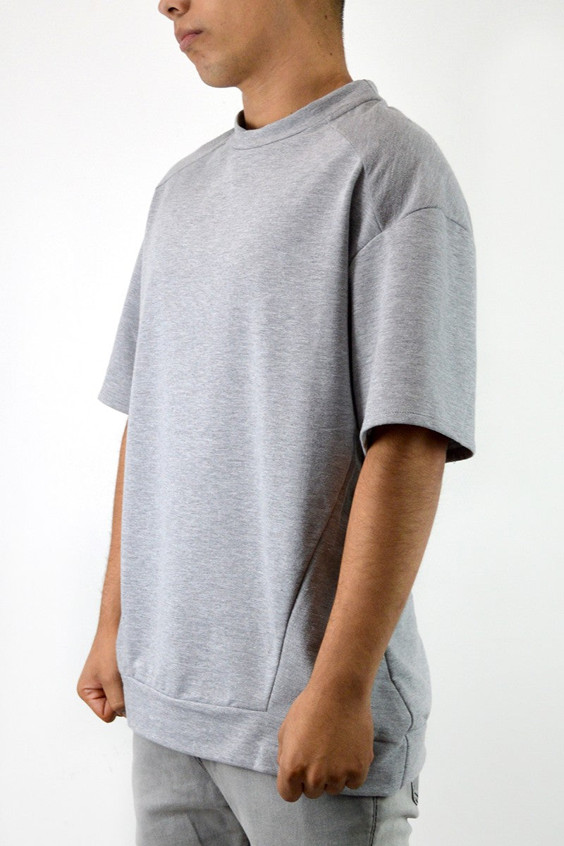 A stylish Reverse French Terry Tee featuring an oversized 1/2 sleeve design, made from 100% cotton, displayed on a mannequin.