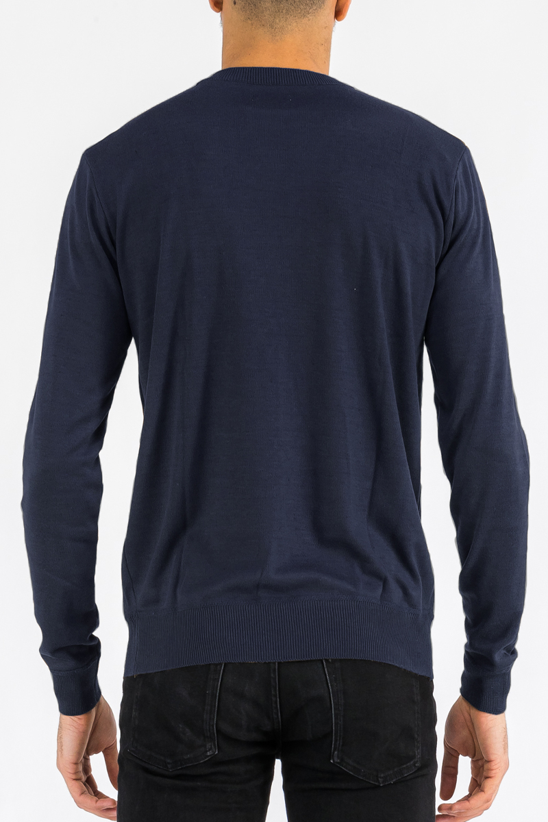 A cozy round neck knit sweater in a soft fabric, showcasing a classic design suitable for casual wear.