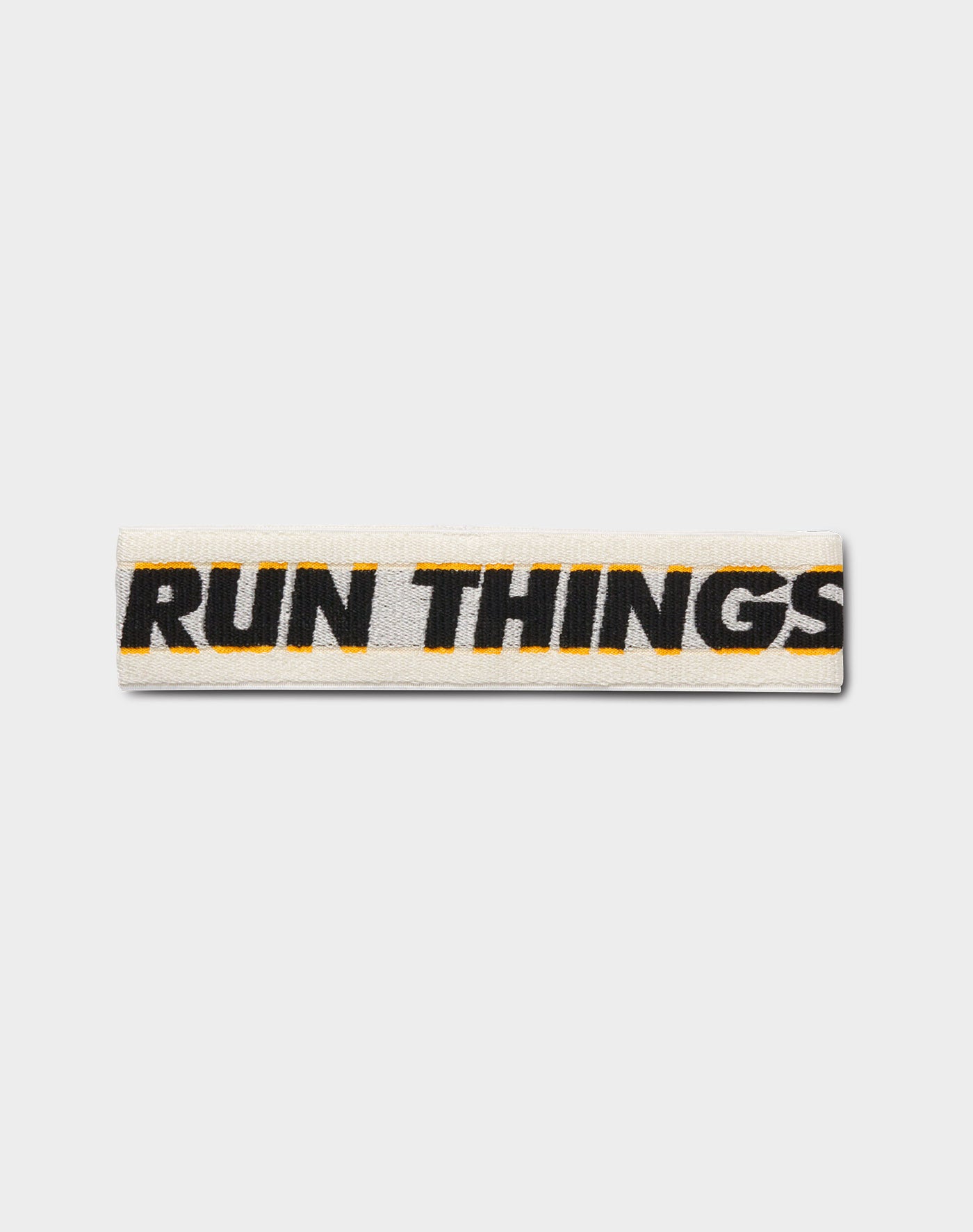 Run Things® Knit Logo Headband featuring black and gold stripes with jacquard knit logo, designed for comfort and style.