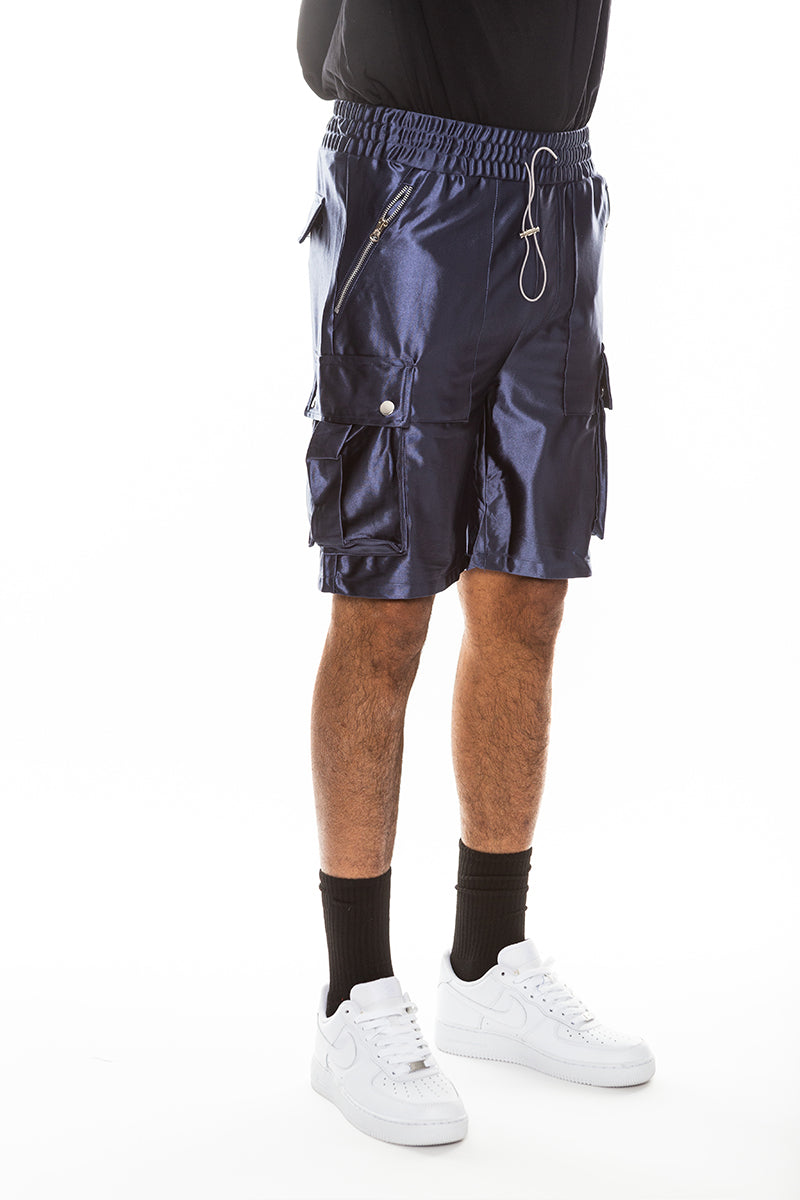 A pair of stylish satin cargo shorts featuring a colored drawstring, zippered pockets, and snap button cargo pockets, perfect for casual wear.