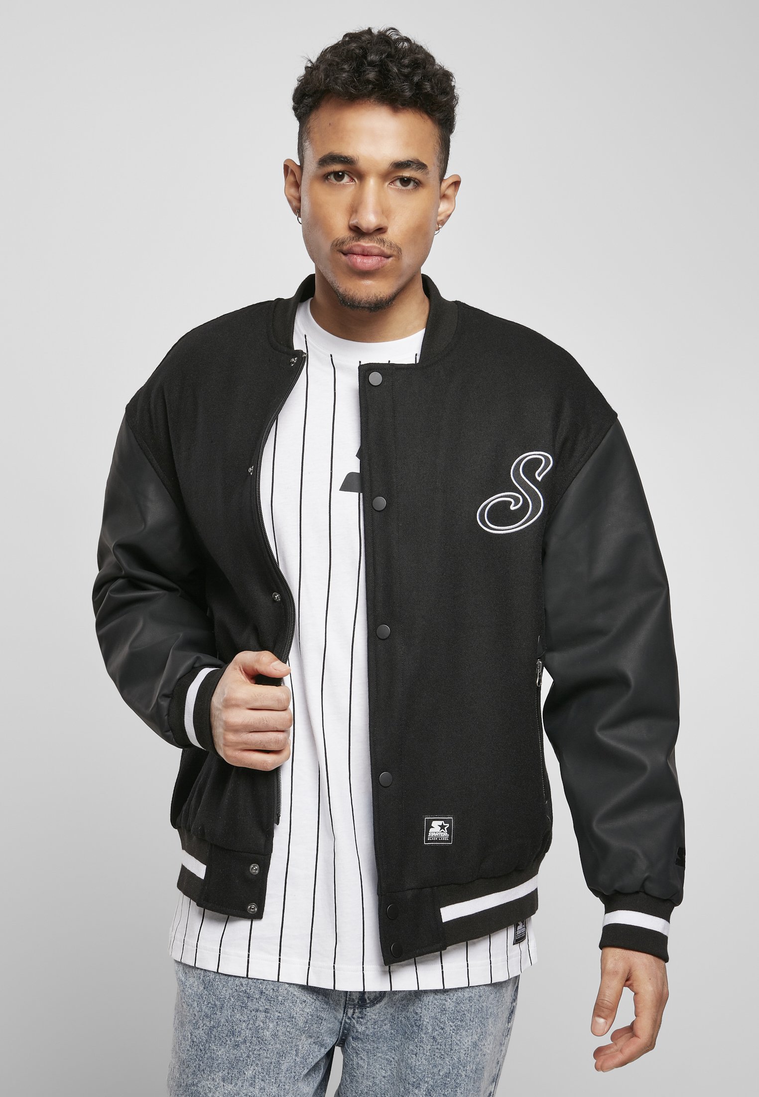 Men's Script College Jacket featuring faux leather sleeves, striped cuffs, and 'Starter' lettering on the back.