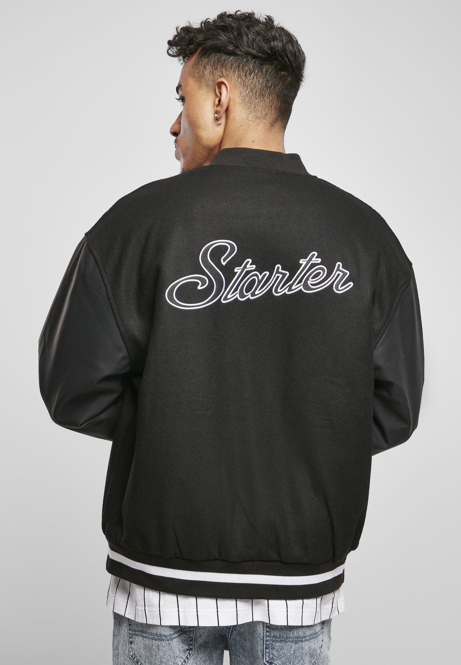 Men's Script College Jacket featuring faux leather sleeves, striped cuffs, and 'Starter' lettering on the back.