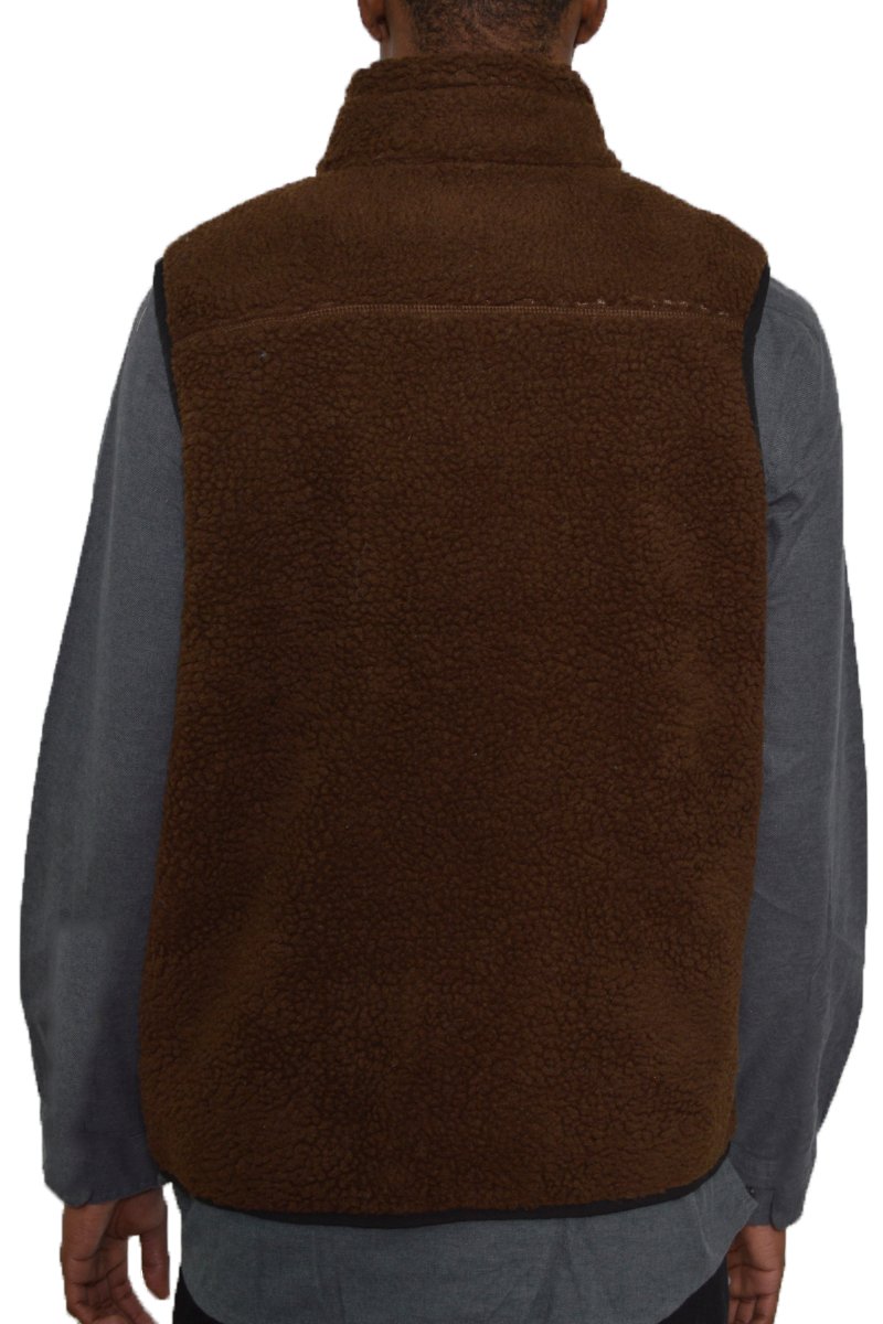 A cozy Sherpa fleece vest featuring a zip-up front and zippered pockets, perfect for layering in cold weather.