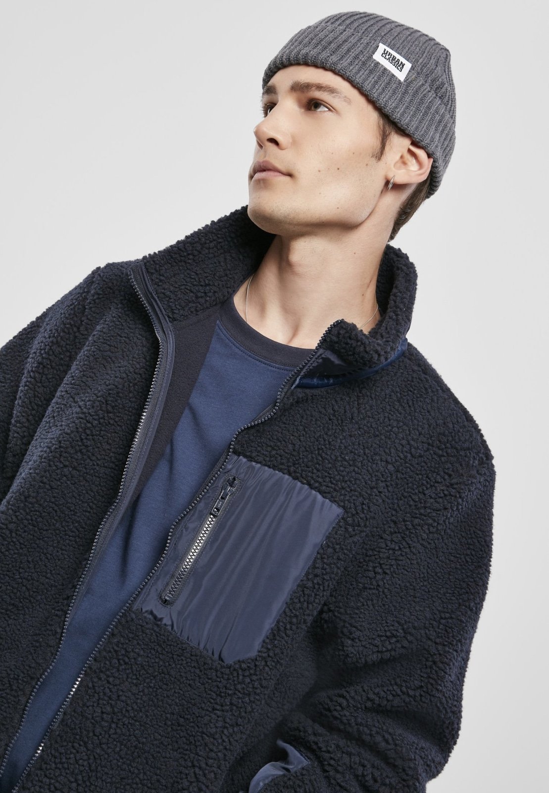 Men's Sherpa Jacket in Midnight Navy with zippered pockets and nylon inserts, showcasing a stylish and fluffy design.