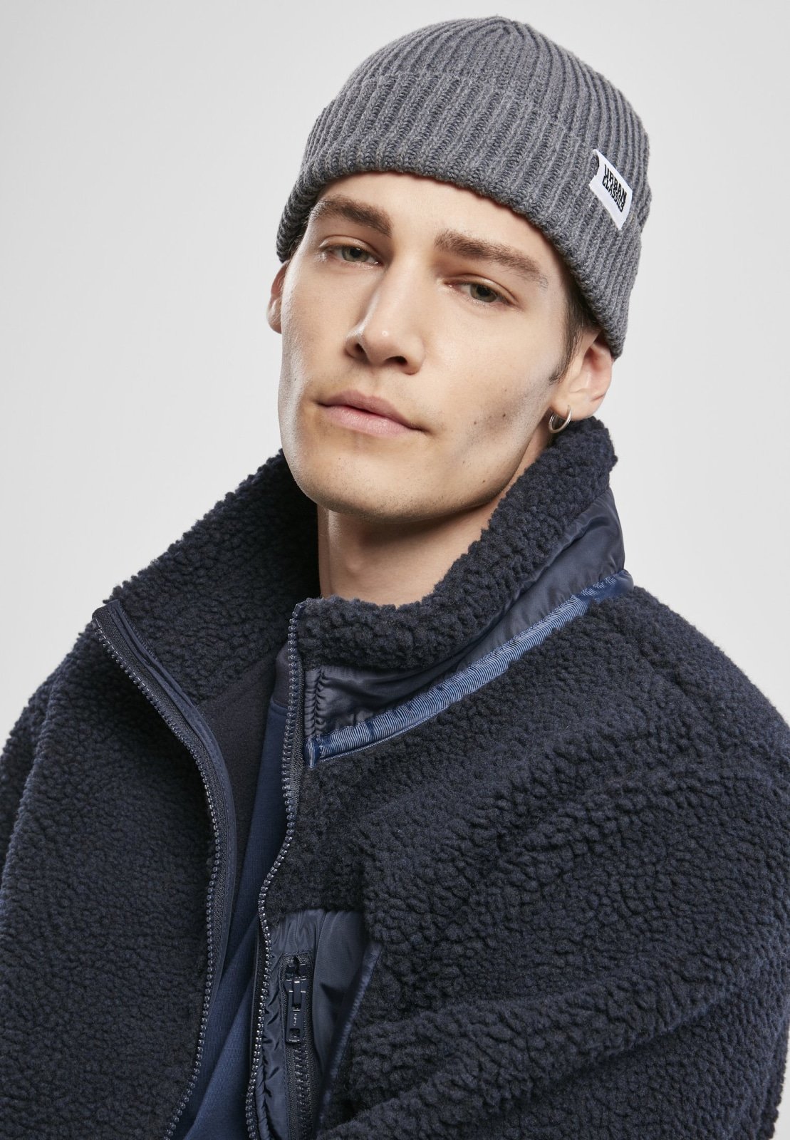 Men's Sherpa Jacket in Midnight Navy with zippered pockets and nylon inserts, showcasing a stylish and fluffy design.