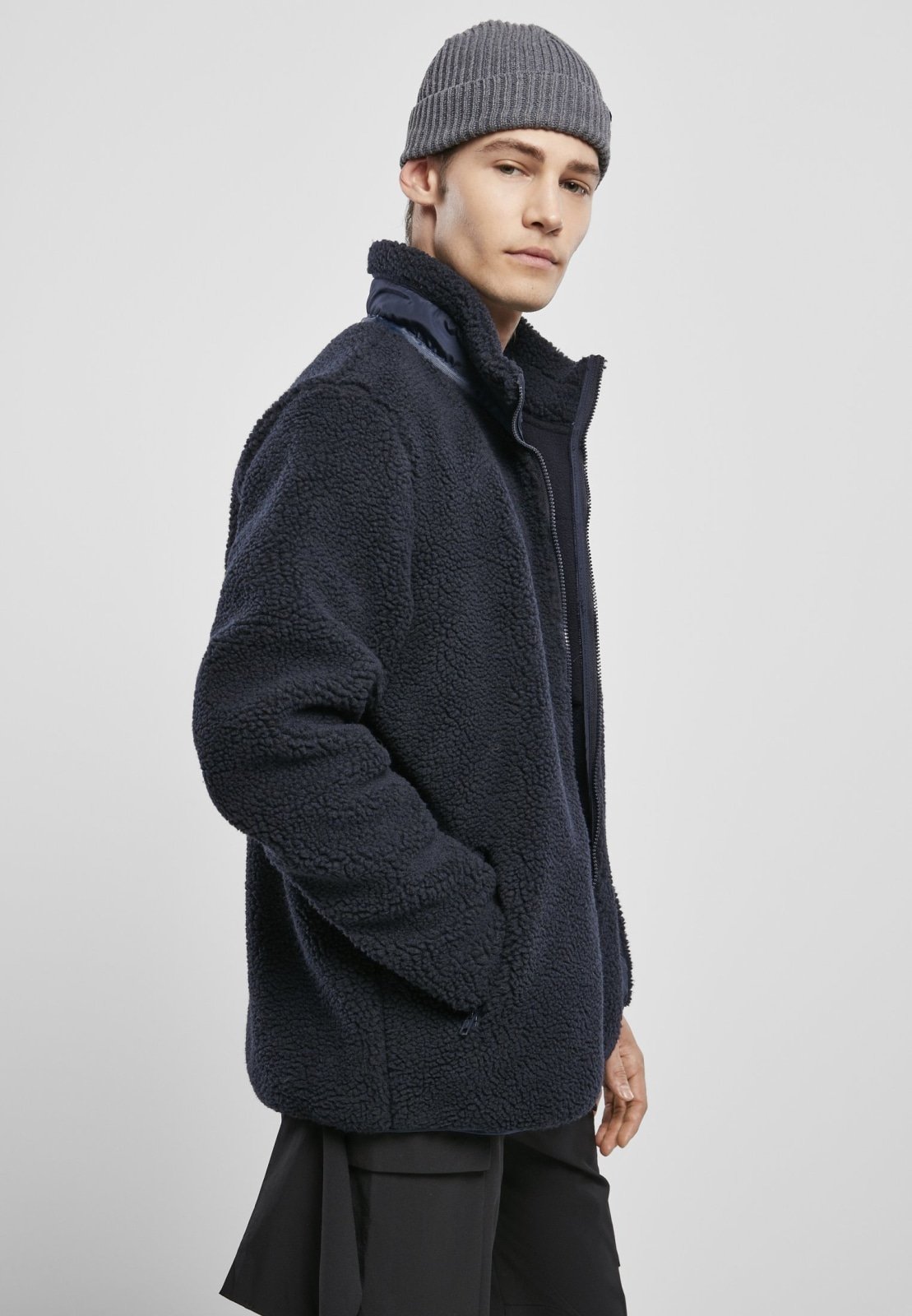 Men's Sherpa Jacket in Midnight Navy with zippered pockets and nylon inserts, showcasing a stylish and fluffy design.