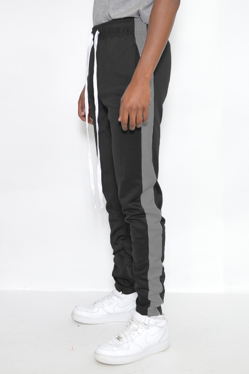 A pair of sleek slim fit track pants featuring a single stripe detail and hidden ankle zippers, perfect for active wear.