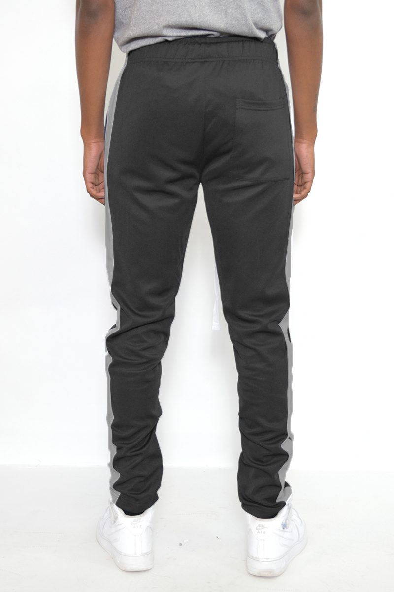 A pair of sleek slim fit track pants featuring a single stripe detail and hidden ankle zippers, perfect for active wear.