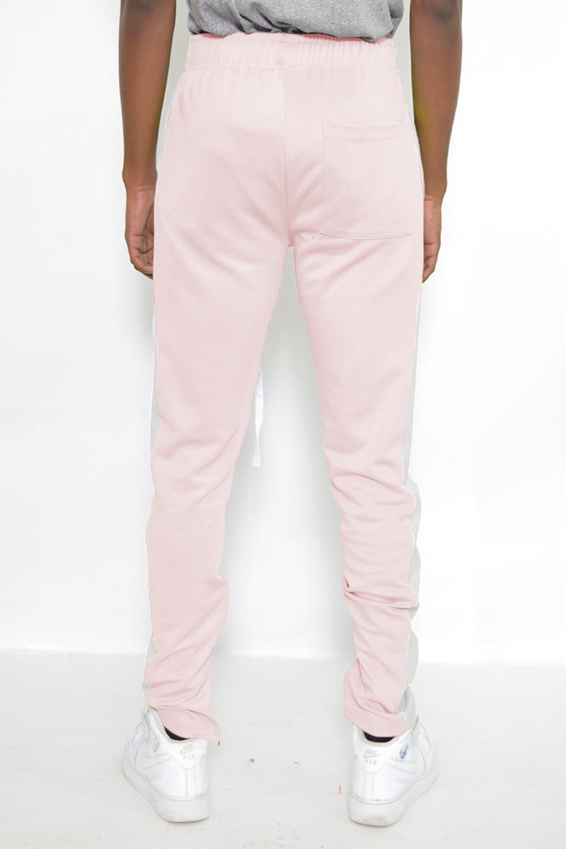 A pair of stylish slim fit track pants featuring a single stripe detail and hidden ankle zippers, perfect for workouts and casual wear.