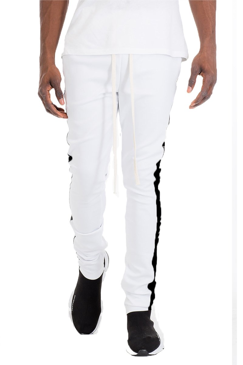 A pair of slim fit track pants featuring a single stripe detail, tug-free zipper closure, and hidden ankle zipper, made from polyester and spandex.