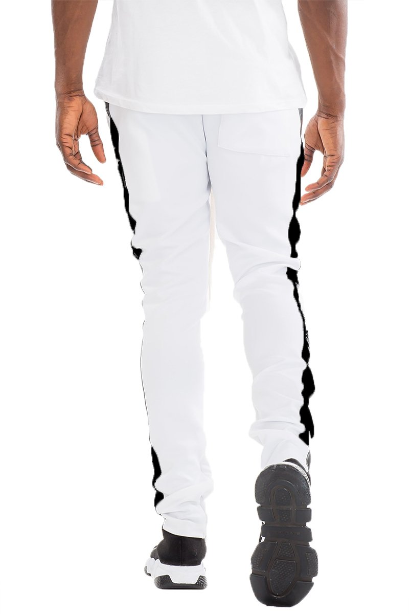 A pair of slim fit track pants featuring a single stripe detail, tug-free zipper closure, and hidden ankle zipper, made from polyester and spandex.