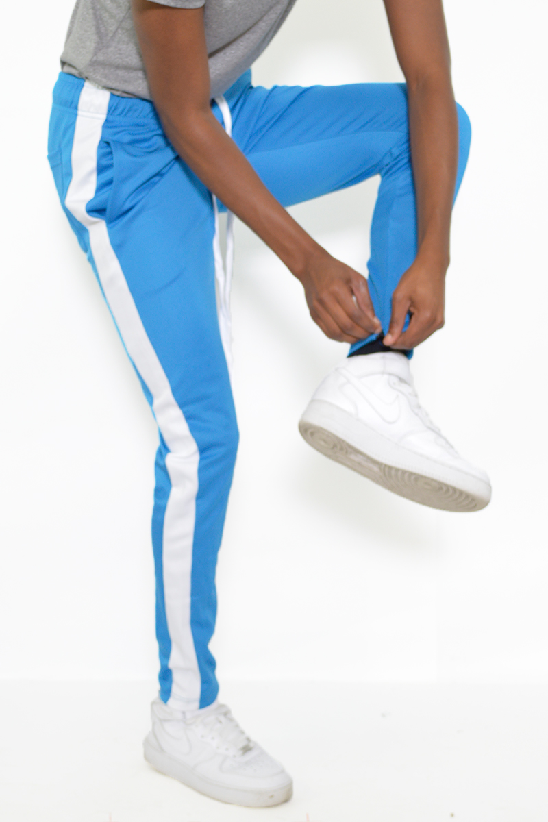 A pair of sleek slim fit track pants featuring a single stripe detail and hidden ankle zippers, perfect for workouts and casual wear.