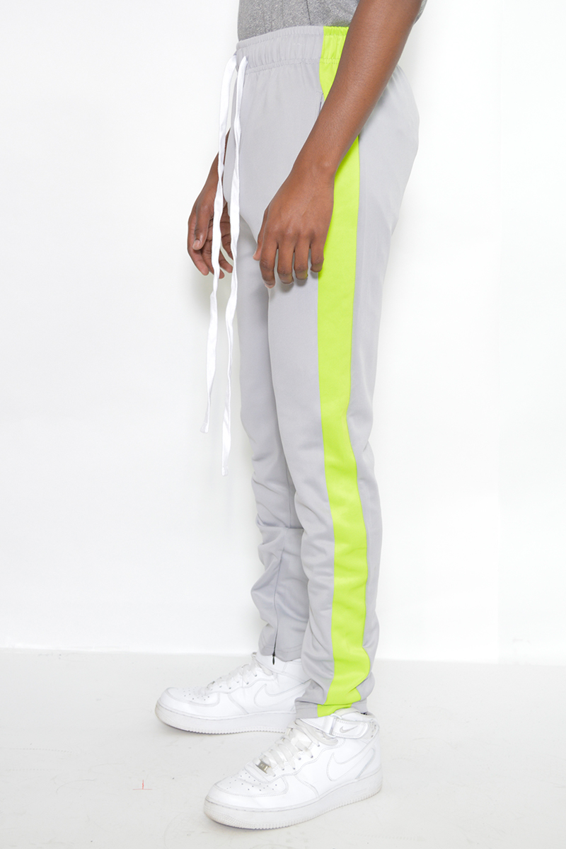 A pair of stylish slim fit track pants featuring a single stripe detail and hidden ankle zipper, perfect for workouts and casual wear.