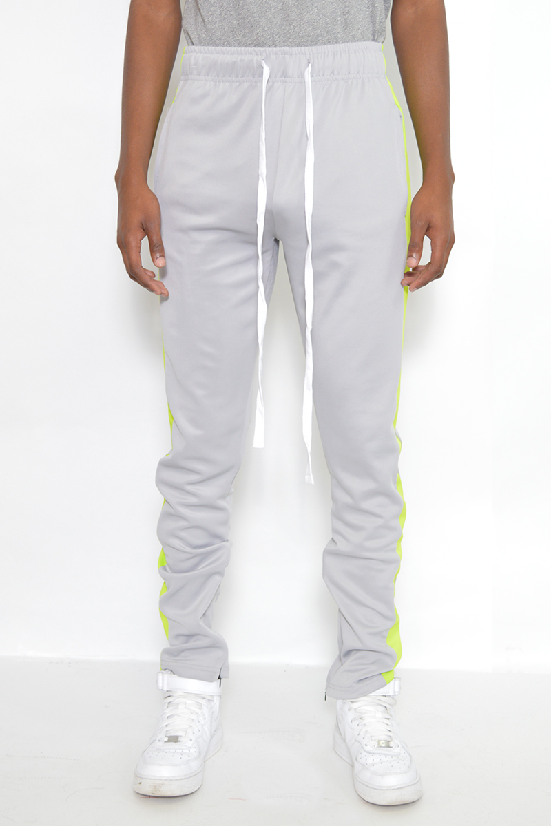 A pair of stylish slim fit track pants featuring a single stripe detail and hidden ankle zipper, perfect for workouts and casual wear.