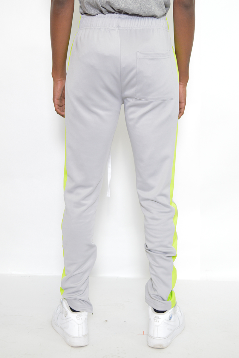 A pair of stylish slim fit track pants featuring a single stripe detail and hidden ankle zipper, perfect for workouts and casual wear.