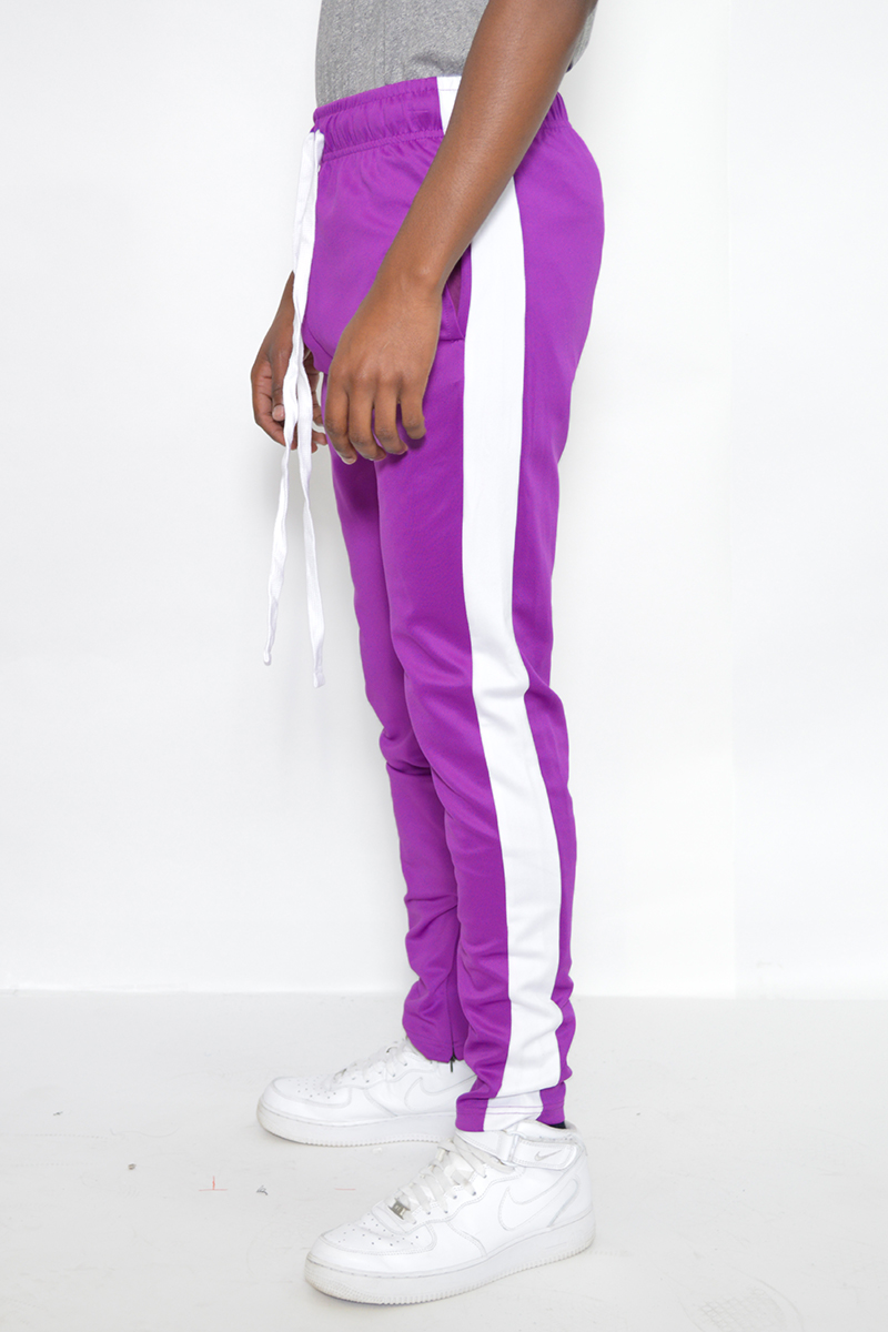 A pair of sleek slim fit track pants featuring a single stripe detail and hidden ankle zippers, perfect for workouts and casual wear.