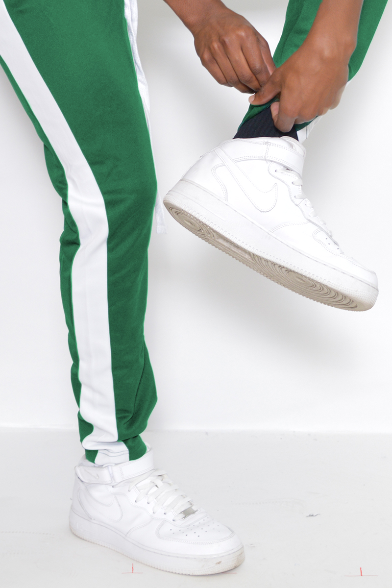 A pair of sleek slim fit track pants featuring a single stripe detail and hidden ankle zipper, perfect for workouts and casual wear.