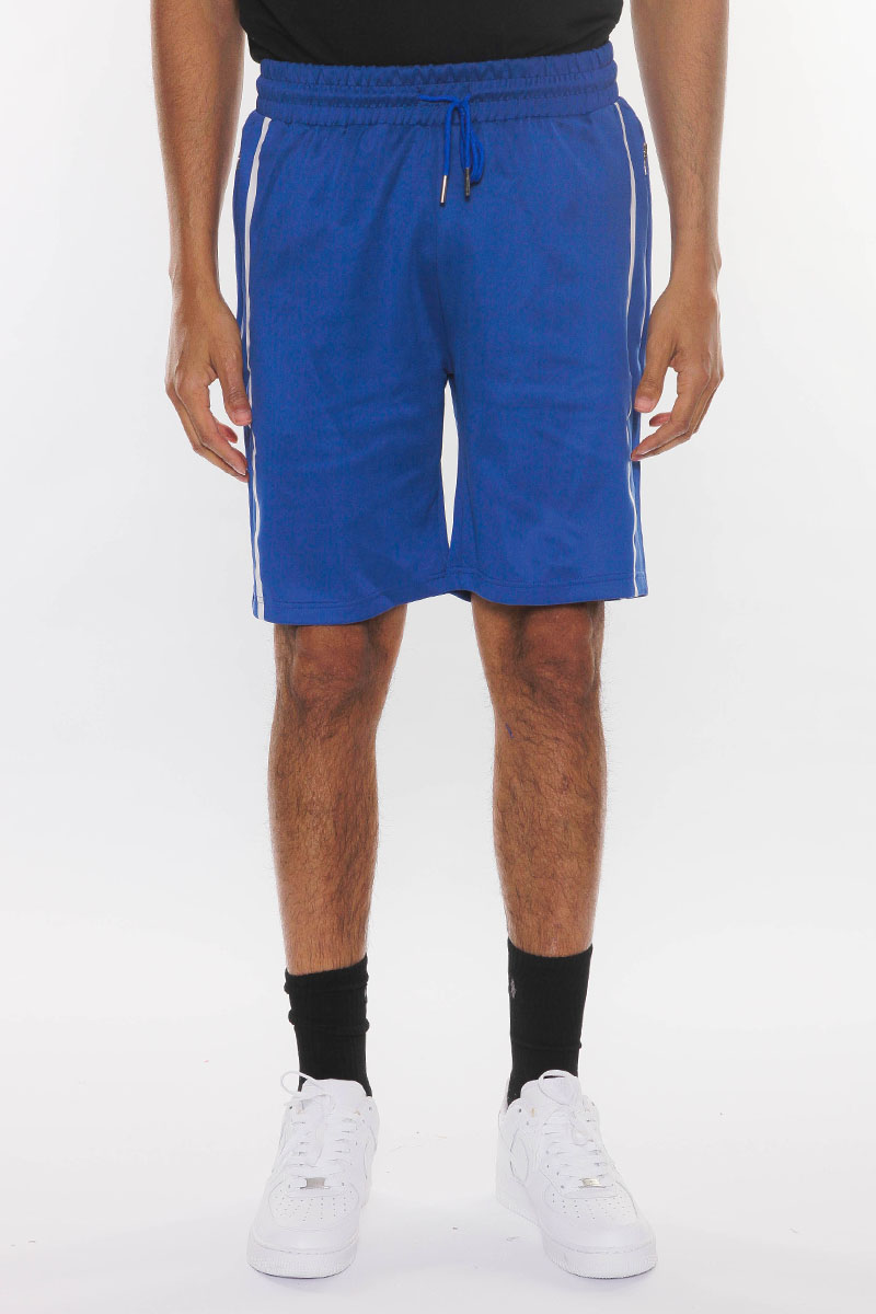 SOLID ATHLETE TAPE SHORTS featuring an elastic waist, drawstring, and zippered pockets, modeled by a person standing at 5'11 in a medium size.