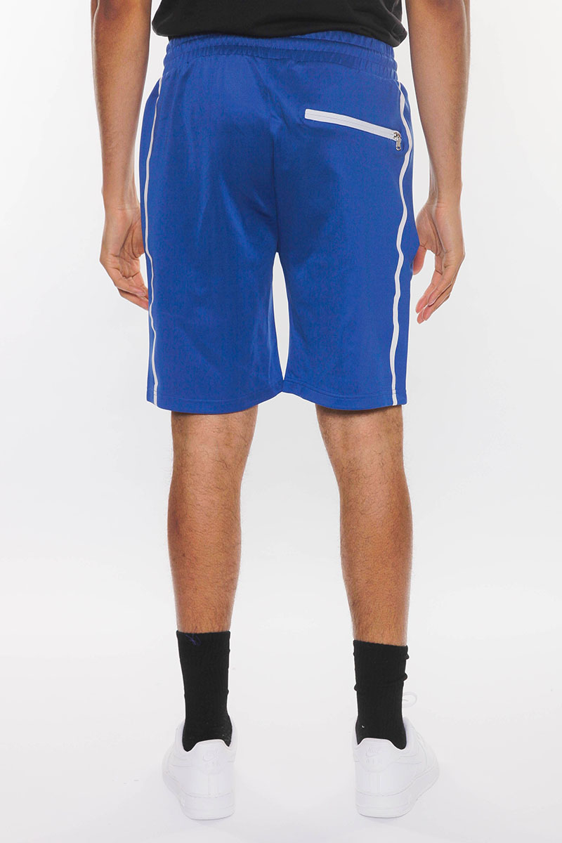 SOLID ATHLETE TAPE SHORTS featuring an elastic waist, drawstring, and zippered pockets, modeled by a person standing at 5'11 in a medium size.