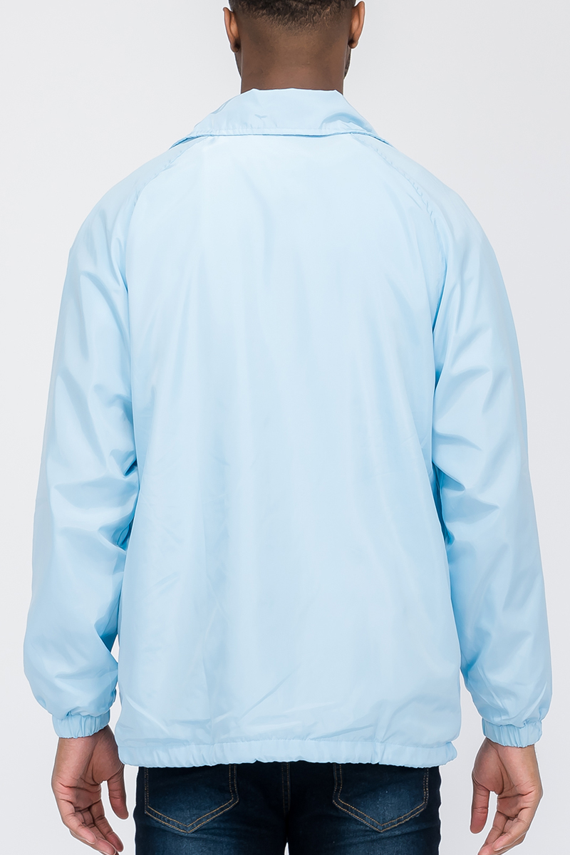 Solid Coachs Jacket in stylish design with snap button closure, made from weather-resistant 100% polyester.