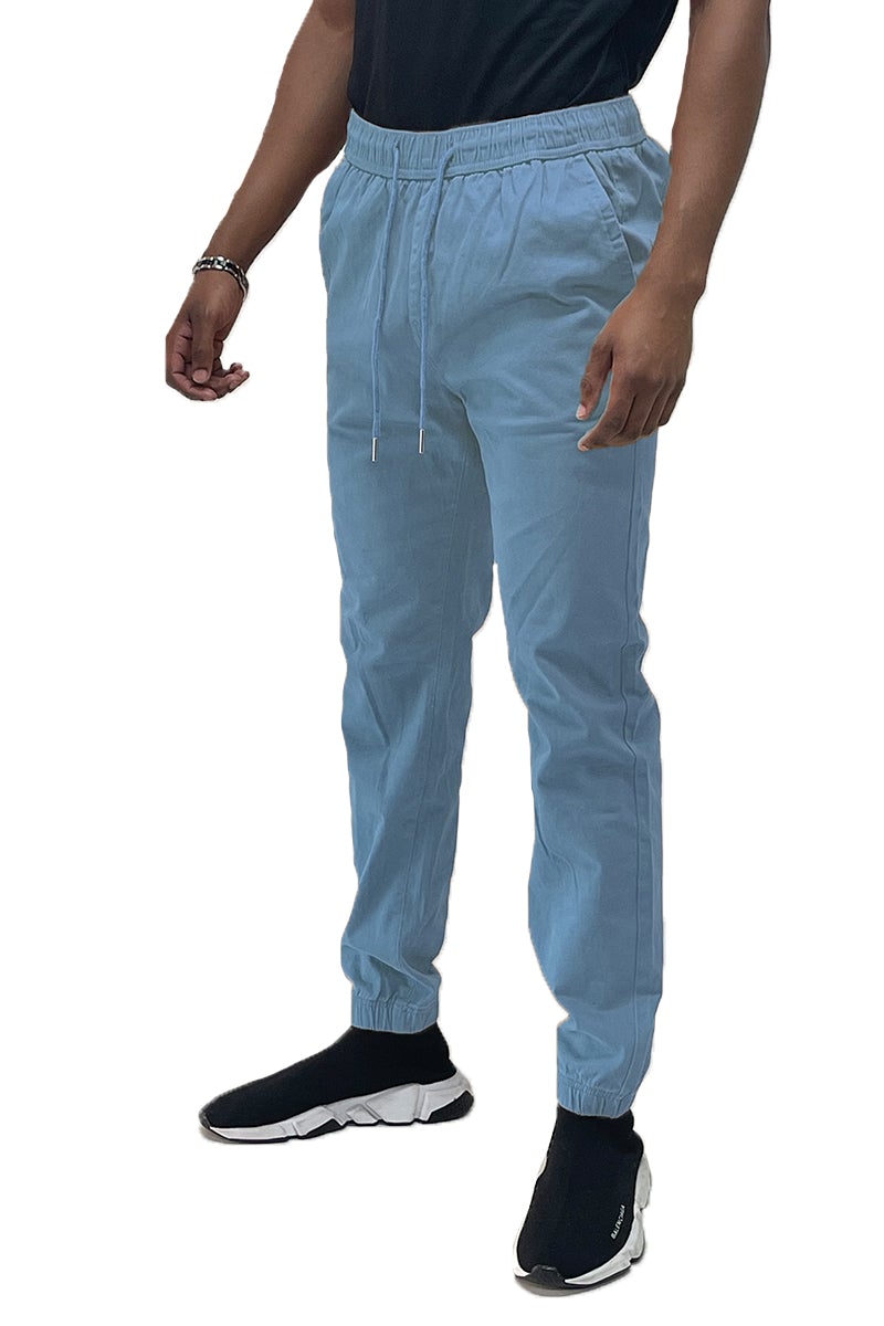 A pair of stylish solid jogger pants featuring an elastic waist and ankle, with standard and back pockets, made from a soft cotton blend.