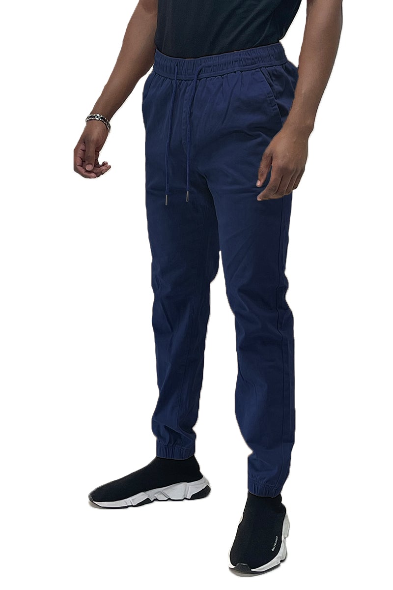 A pair of stylish solid jogger pants featuring an elastic waist and ankle, with standard and back pockets, made from a soft cotton blend.