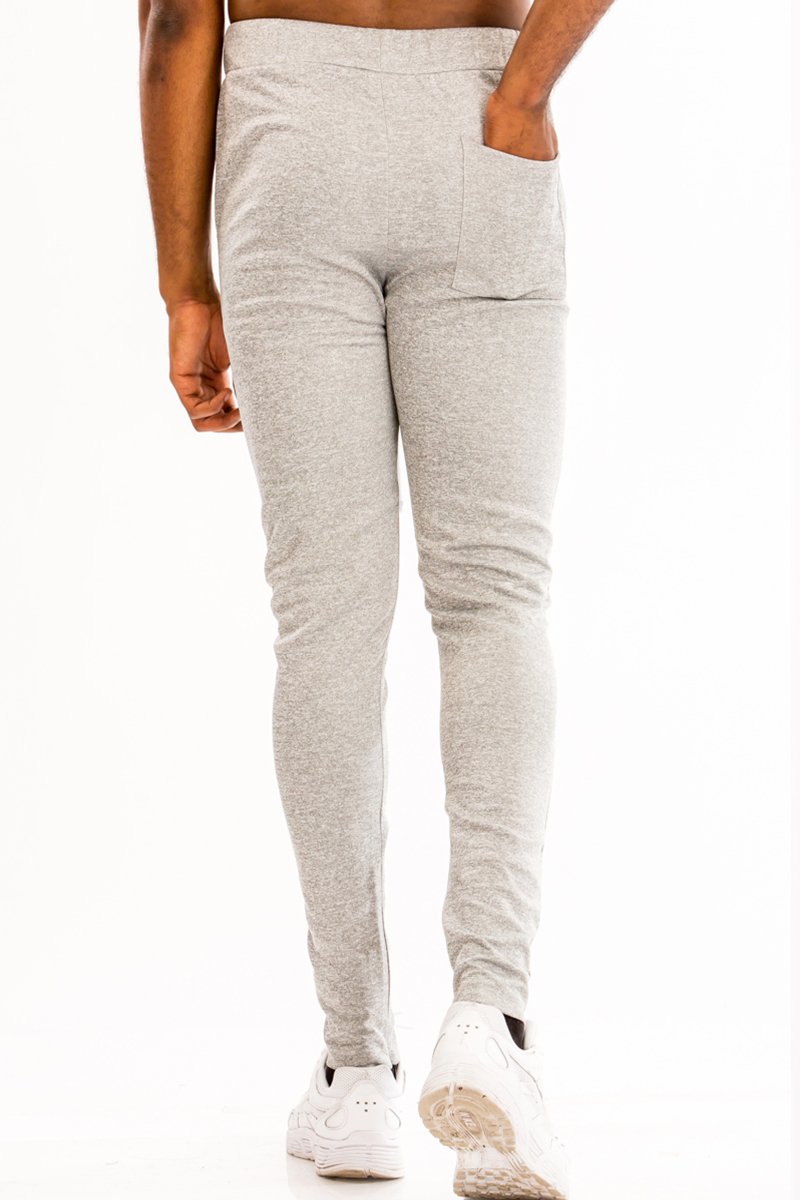 A pair of sleek solid track pants featuring a skinny fit, elastic waist with drawstring, and hidden ankle zipper, perfect for active wear.