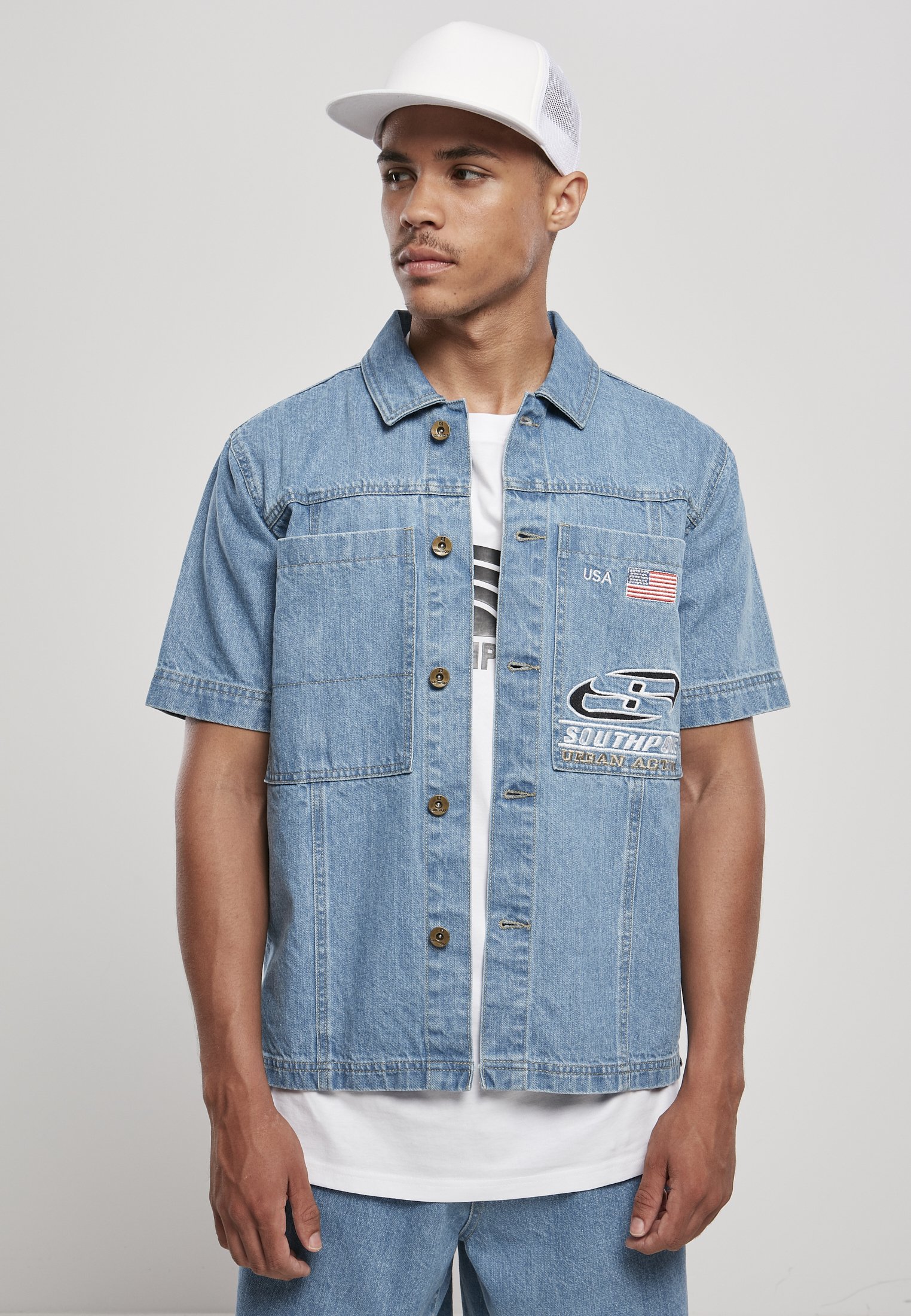 Men's Southpole Denim Shirt featuring button placket, turn-down collar, and large patch chest pockets with USA and Southpole logo embroidery.