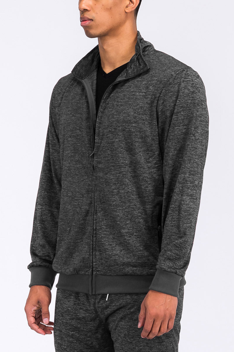 A stylish speckled performance jacket featuring a full zip, elastic waist, and standard pockets, perfect for athletic activities.