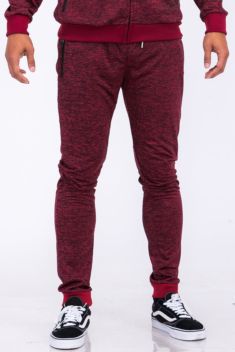 A pair of stylish speckled performance joggers featuring an elastic waist, cuffed ankles, and multiple pockets, perfect for workouts and casual wear.