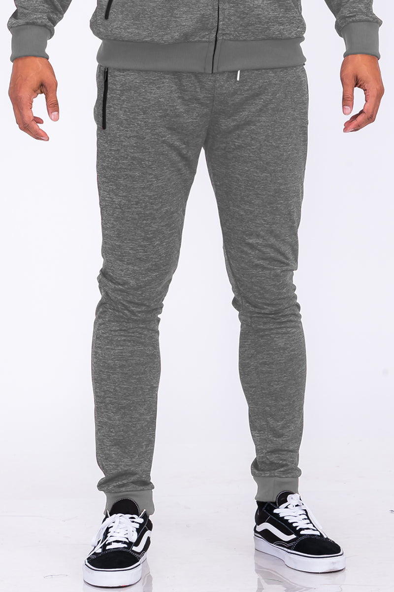 A pair of stylish speckled performance joggers featuring an elastic waist, cuffed ankles, and multiple pockets, perfect for workouts and casual wear.