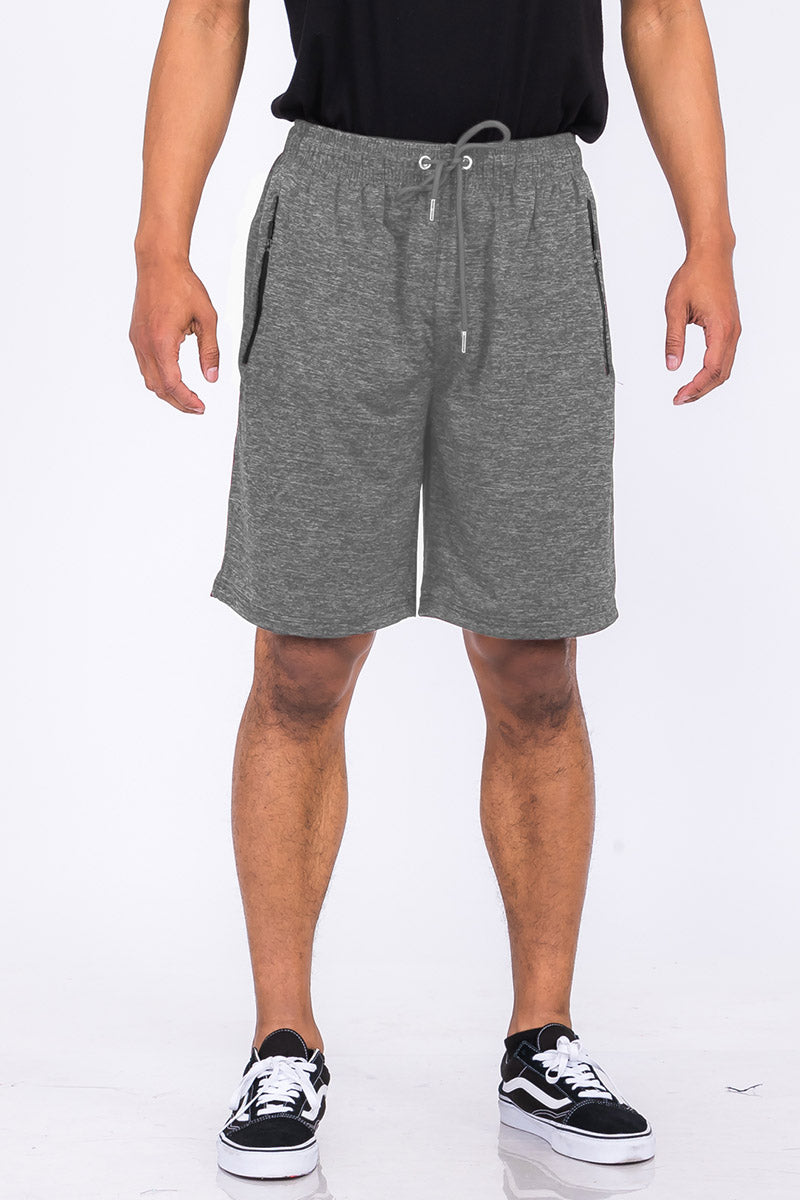 A pair of speckled performance shorts featuring an elastic waist, drawstring, and pockets, designed for comfort and mobility.