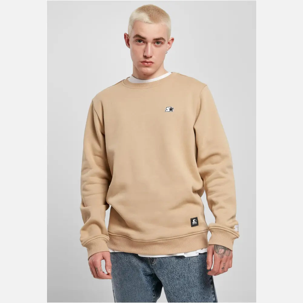 A cozy Starter Essential Crewneck Sweatshirt in various colors, showcasing its soft brushed fleece fabric and classic crewneck design.